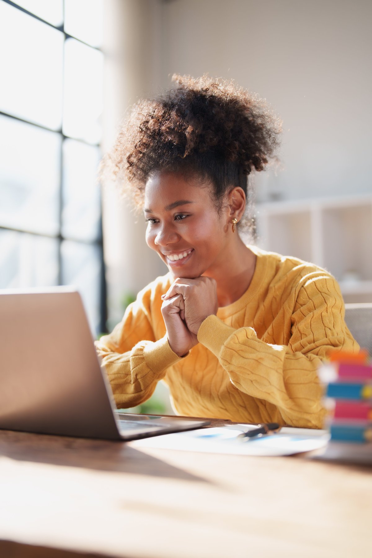 A woman studying wellness education content at home in natural daylight